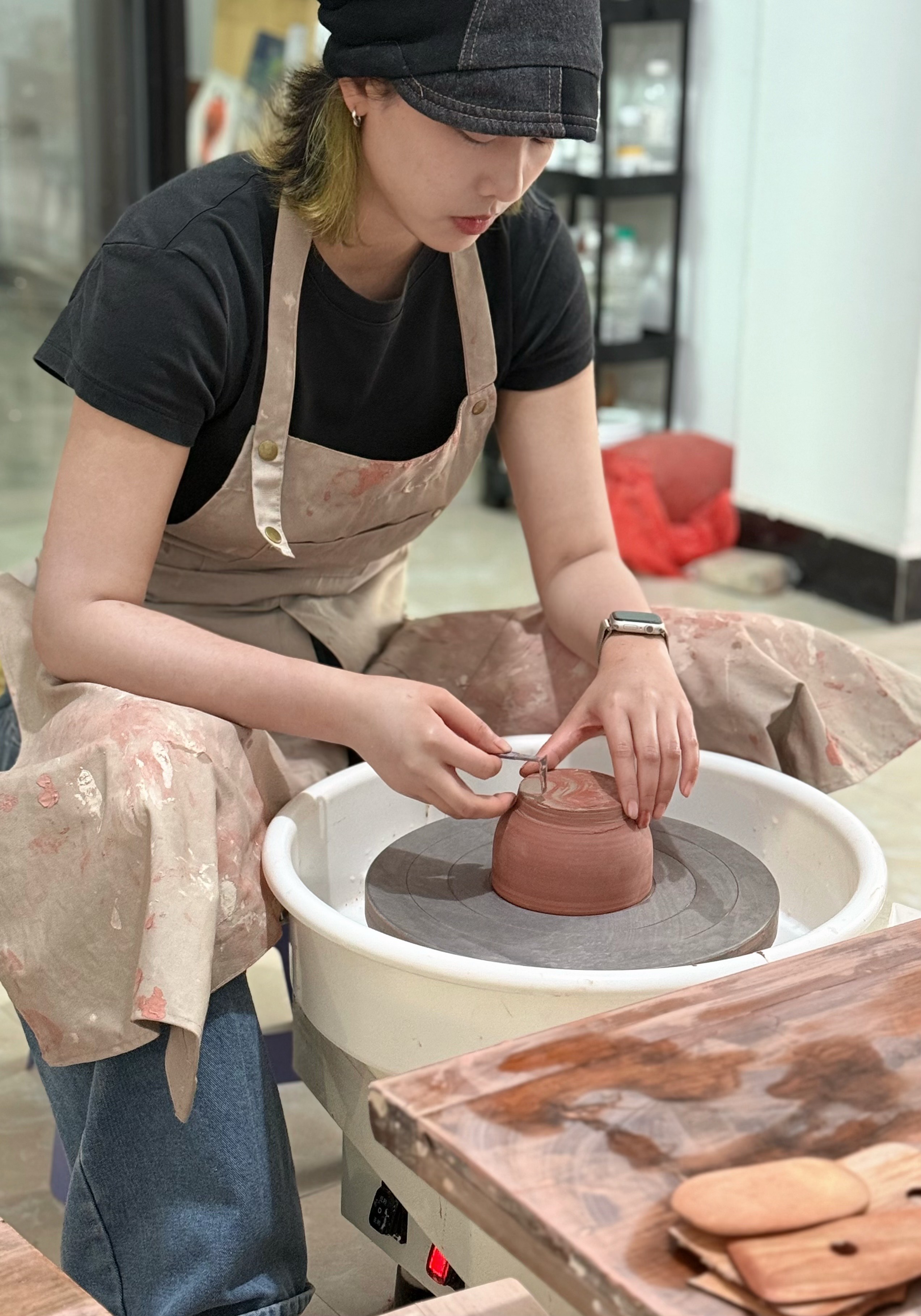 Yoon working at the pottery wheel